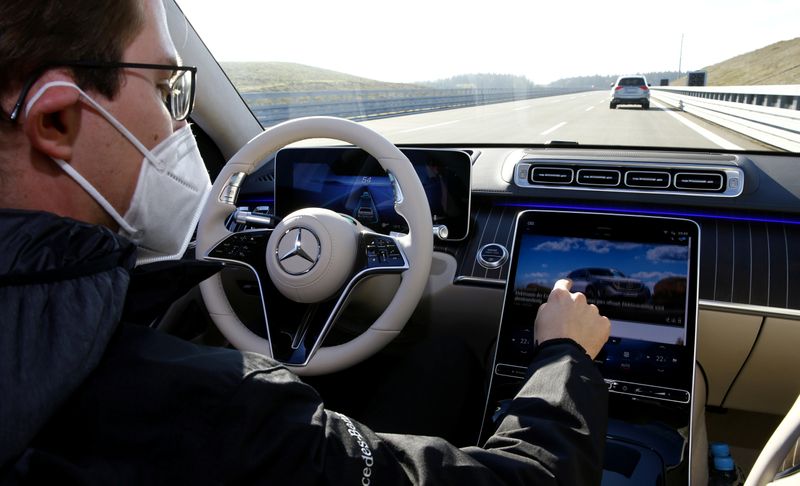 An employee demonstrates steering by autonomous driving system in a new Mercedes-Benz S-Class limousine near Immendingen