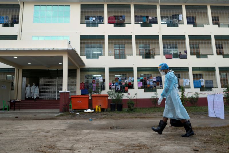 FILE PHOTO: A volunteer wearing a protective suit works at a quarantine center for people infected amid the outbreak of the coronavirus disease in Yangon