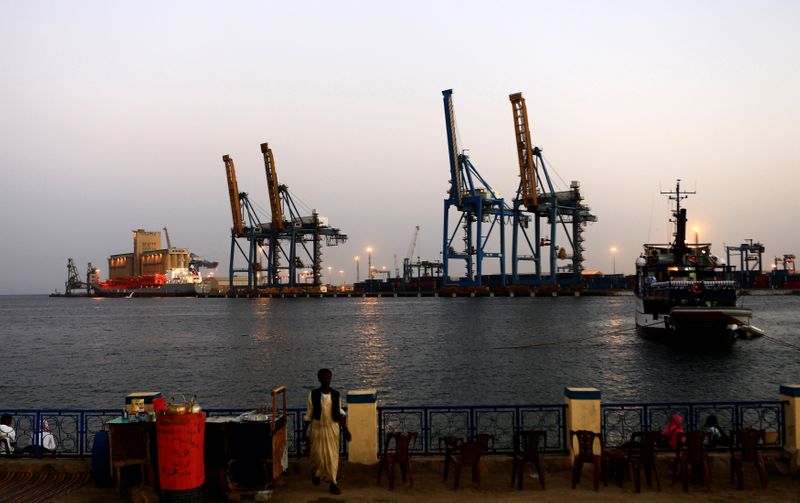 FILE PHOTO: A man stands opposite the modern port at the harbour in Port Sudan at Red Sea State