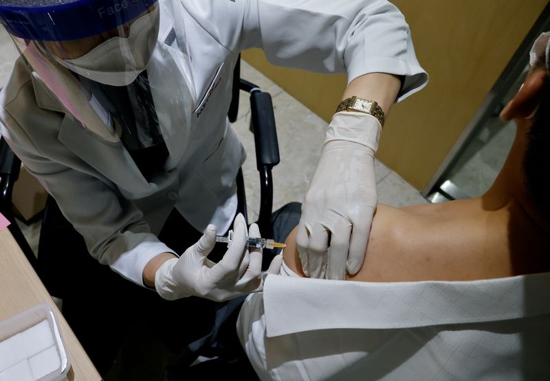 FILE PHOTO: A man gets an influenza vaccine at a branch of the Korea Association of Health Promotion in Seoul