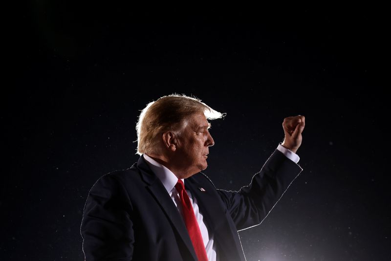 U.S. President Donald Trump makes a fist during a campaign rally at Middle Georgia Regional Airport in Macon, Georgia, U.S.