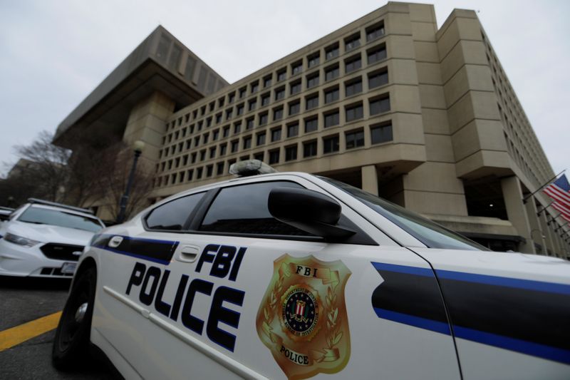 FILE PHOTO: FBI police vehicles sit outside FBI building in Washington
