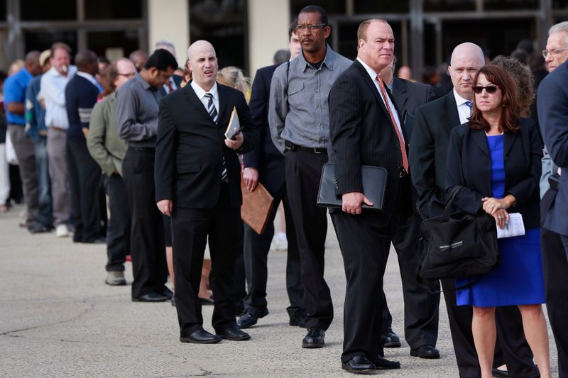 People wait in line to enter the Nassau County Mega Job Fair at Nassau Veterans Memorial Coliseum in Uniondale, New York