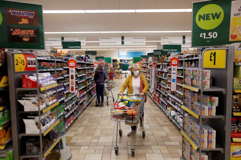 FILE PHOTO: A customer wearing a protective face mask shops at a Morrisons store in St Albans