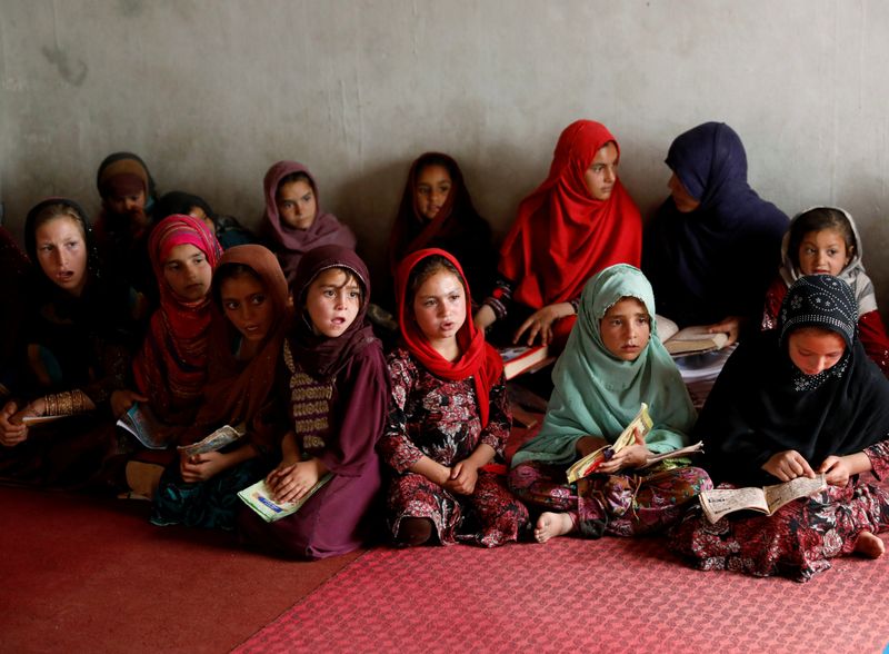Internally displaced Afghan girls read the Koran at a mosque, amidst the spread of the coronavirus disease (COVID-19) during the holy fasting month of Ramadan, in Kabul