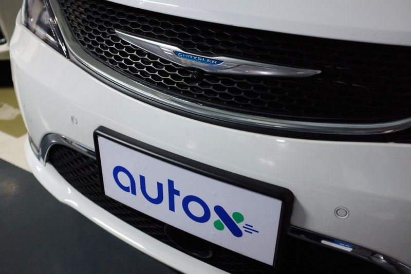 Sign of Alibaba-backed autonomous driving startup AutoX is seen on a modified Chrysler Pacifica minivan in Shenzhen