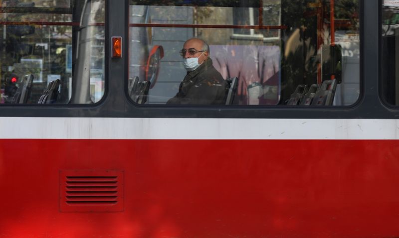 Man wearing protective face mask rides on a train in Sofia