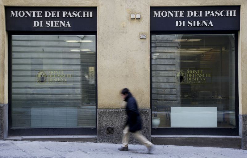FILE PHOTO: A man walks in front of the Monte dei Paschi bank in Siena