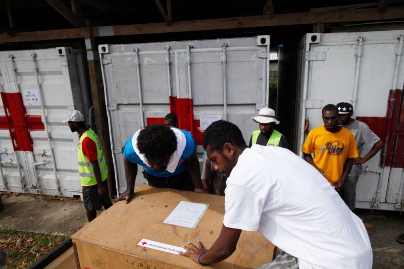 Volunteers load up aid equipment to be delivered to outlying islands at a Red Cross aid centre, days after Cyclone Pam in Port Vila, capital city of Vanuatu