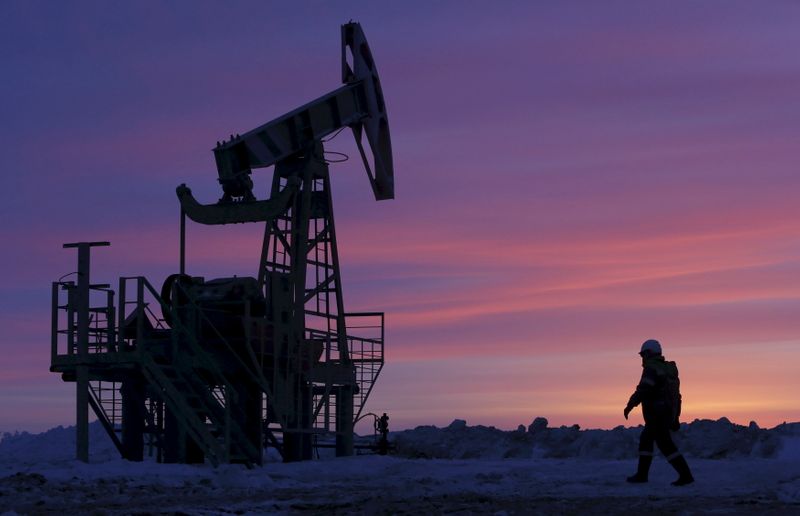 File photo of a worker walking past a pump jack on an oil field owned by Bashneft, Bashkortostan