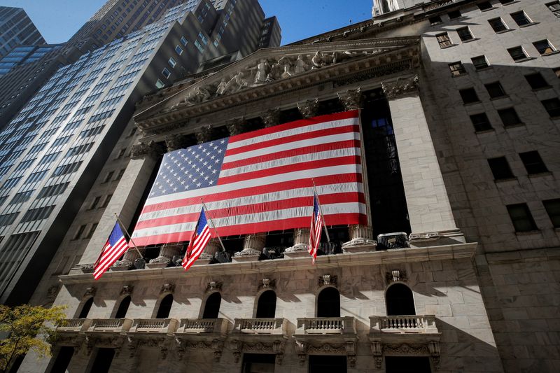FILE PHOTO: The U.S. flag covers the front facade of the NYSE in New York