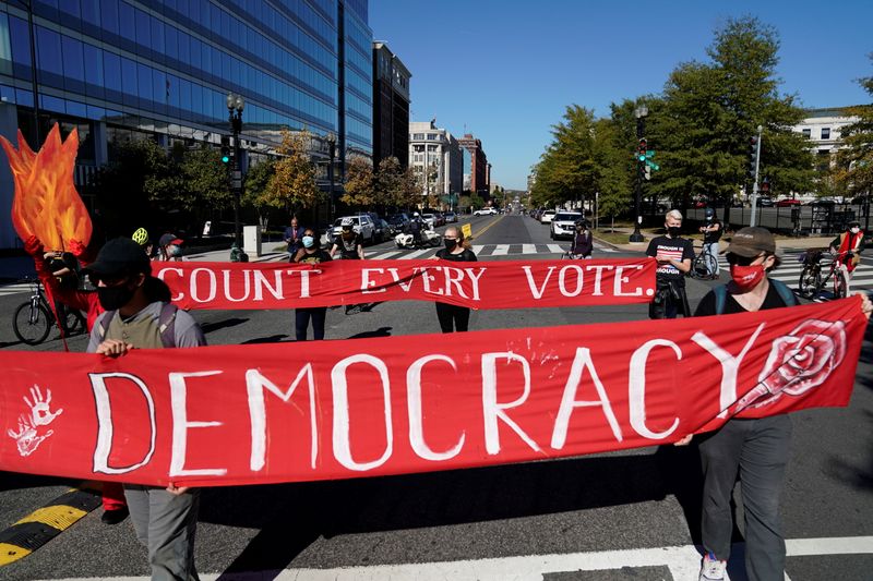 Activists take part in a protest led by shutdownDC the day after the 2020 U.S. presidential election in Washington