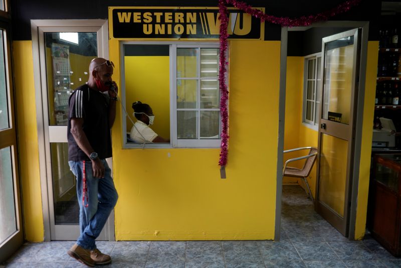 A man talks on the phone outside a Western Union office, in Havana