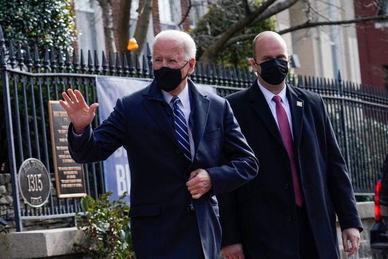 U.S. President Joe Biden gestures as he leaves the Holy Trinity Catholic Church in Washington
