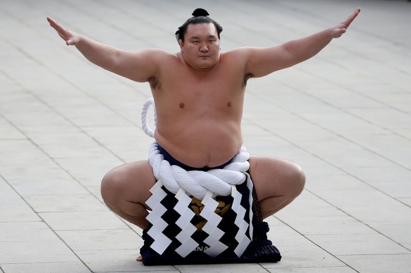 FILE PHOTO - Mongolian-born grand sumo champion yokozuna Hakuho performs the New Year's ring-entering rite at the annual celebration for the New Year at Meiji Shrine in Tokyo