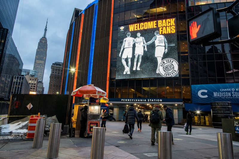 People walk outside Madison Square Garden before a Knicks game amid the coronavirus disease (COVID-19) pandemic in the Manhattan borough of New York City, New York
