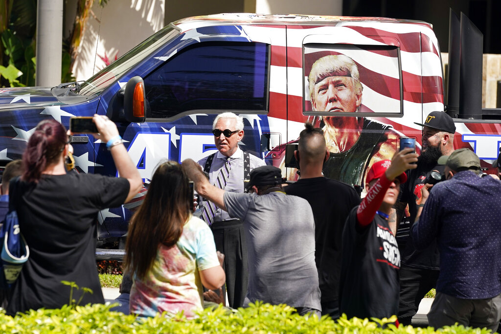 Conservative political consultant, Roger Stone, center, arrives outside the convention center at the Conservative Political Action Conference (CPAC) Saturday, Feb. 27, 2021, in Orlando, Fla. (AP Photo/John Raoux)