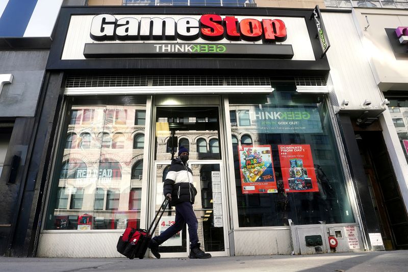 FILE PHOTO: A person walks past a GameStop in New York