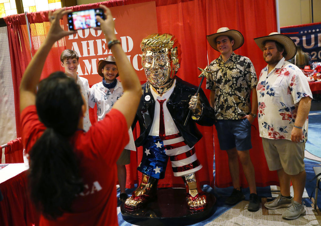 ORLANDO, FLORIDA - FEBRUARY 27: People take a picture with former President Donald Trump's statue on display at the Conservative Political Action Conference held in the Hyatt Regency on February 27, 2021 in Orlando, Florida. Begun in 1974, CPAC brings together conservative organizations, activists, and world leaders to discuss issues important to them. (Photo by Joe Raedle/Getty Images)