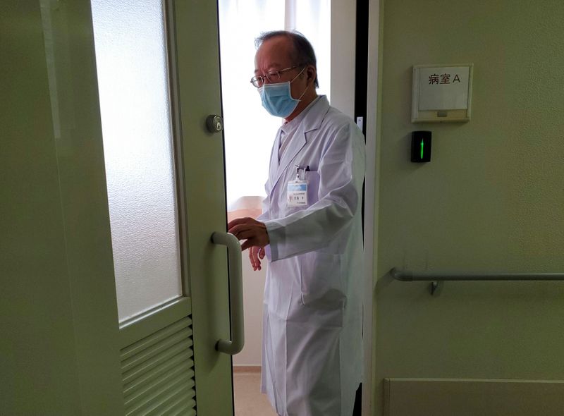 Manabu Yoneshima walks at his hospital in Tsuruga