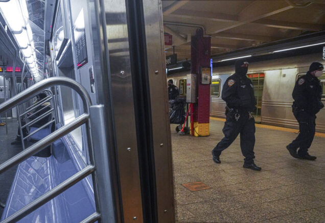 Police patrol the A line subway train bound to Inwood, after NYPD deployed an additional 500 officers into the subway system following deadly attacks, Saturday Feb. 13, 2021, in New York. Authorities say an unidentified man could be responsible for four separate stabbing attacks in the New York City subways that have left two people dead. New York police say the assaults happened between Friday morning and early Saturday. (AP Photo/Bebeto Matthews)