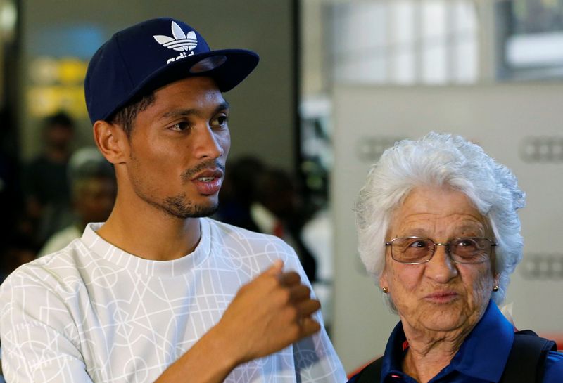 South Africa's Rio 2016 Summer Olympic Games gold medalist, Wayde van Niekerk and his coach, Ans Botha look on after their arrival at the O.R Tambo International Airport in Johannesburg