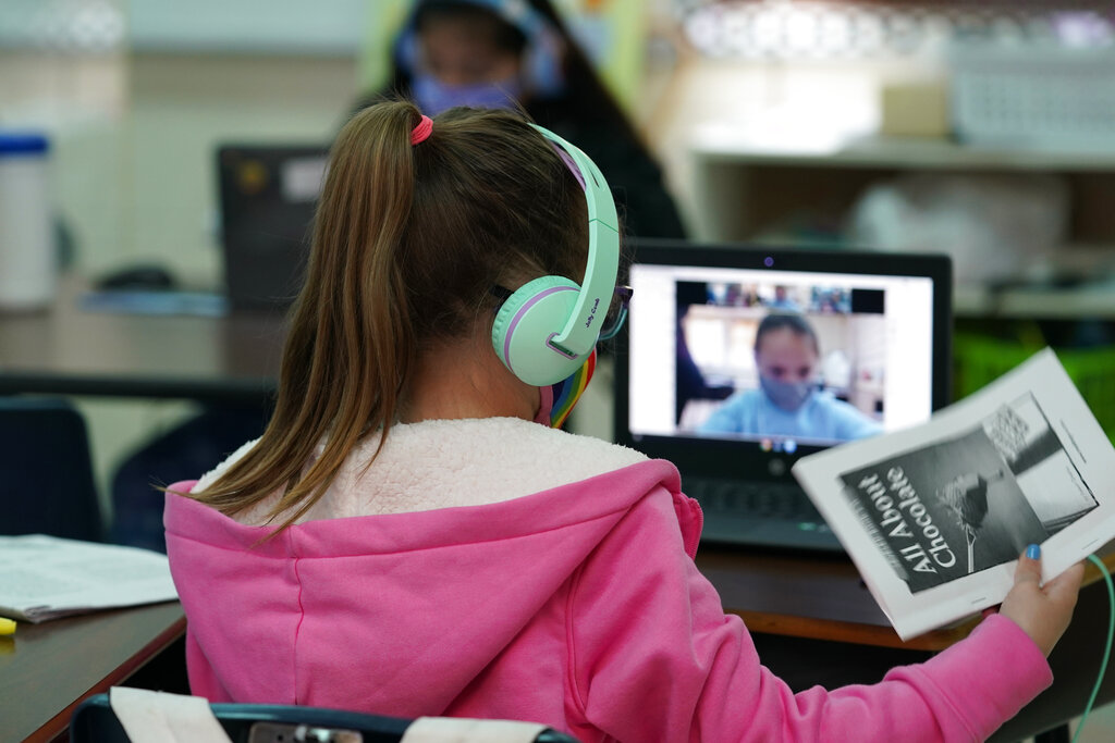 Students at Driggers Elementary School attend a class in-person as they interact with classmates virtually, Monday, Feb. 8, 2021, in San Antonio. After seeing two academic years thrown off course by the pandemic, school leaders around the country are planning for the possibility of more distance learning next fall at the start of yet another school year. (AP Photo/Eric Gay)