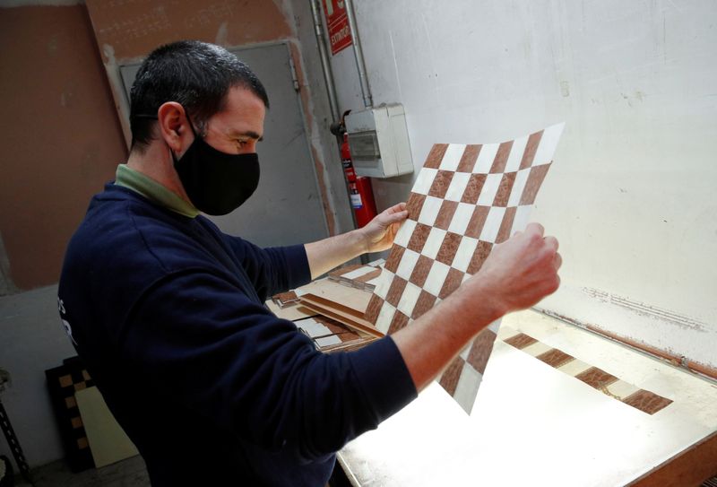 A worker makes a chessboard at the Rechapados Ferrer factory at their factory in La Garriga