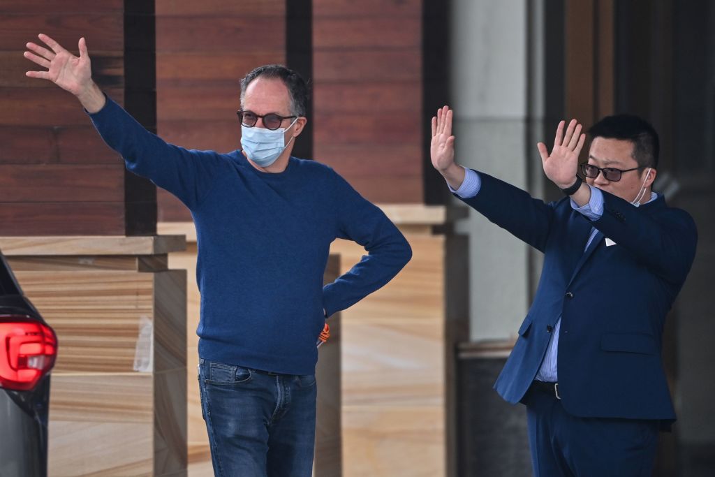 WHO team member Peter Ben Embarek (L) waves as group members Marion Koopmans and Peter Daszak leave their hotel after the World Health Organization (WHO) team wrapped up its investigation into the origins of the COVID-19 coronavirus in Wuhan in China's central Hubei province on February 10, 2021. (Photo by Hector RETAMAL / AFP) (Photo by HECTOR RETAMAL/AFP via Getty Images)