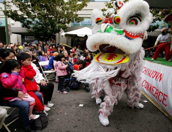 FILE - In this Jan. 21, 2006, file photo, Chinese lion dancers perform in Oakland's Chinatown in Oakland, Calif. Police are stepping up patrol and volunteers are increasing their street presence after several violent attacks on older Asians stoked fear in the San Francisco Bay Area's Chinatowns and subdued the celebratory mood leading up to Chinese New Year. (AP Photo/Paul Sakuma, File)