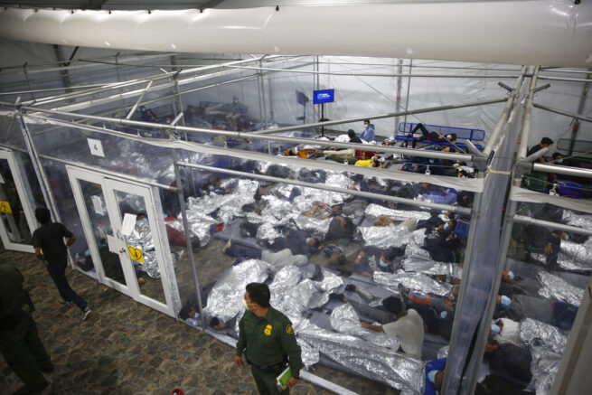 Young minors lie inside a pod at the Donna Department of Homeland Security holding facility, the main detention center for unaccompanied children in the Rio Grande Valley run by U.S. Customs and Border Protection (CBP), in Donna, Texas, Tuesday, March 30, 2021. The minors are housed by the hundreds in eight pods that are about 3,200 square feet in size. Many of the pods had more than 500 children in them. The Biden administration on Tuesday for the first time allowed journalists inside its main detention facility at the border for migrant children, revealing a severely overcrowded tent structure where more than 4,000 kids and families were crammed into pods and the youngest kept in a large play pen with mats on the floor for sleeping.(AP Photo/Dario Lopez-Mills,Pool)