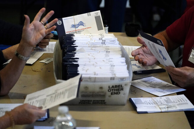 Election workers in Chester County, Pa., process mail-in and absentee ballots for the 2020 general election on Nov. 4. | Matt Slocum/AP Photo