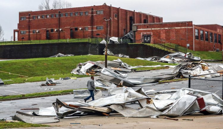 Debris is strewn about the damaged campus of Newnan High School, Friday, March 26, 2022, in Newnan, Ga., the day after a dangerous tornado moved through the area, (John Spink/Atlanta Journal-Constitution via AP)