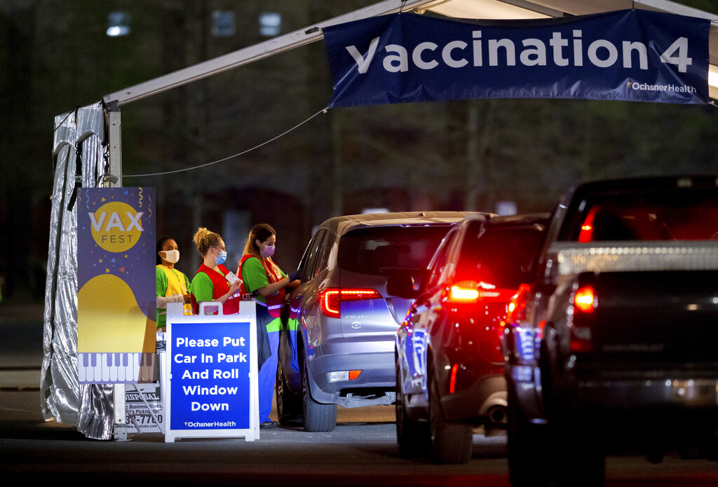 Ochsner nurses and volunteers give a Moderna COVID-19 vaccine at 5 a.m. during the 24-hour Max Fest at the Shrine on Airline Metairie near New Orleans Tuesday, March 30, 2021. Anyone who does not have an appointment can show up and get a vaccine until 7 a.m. this morning. (David Grunfeld/The Advocate via AP)