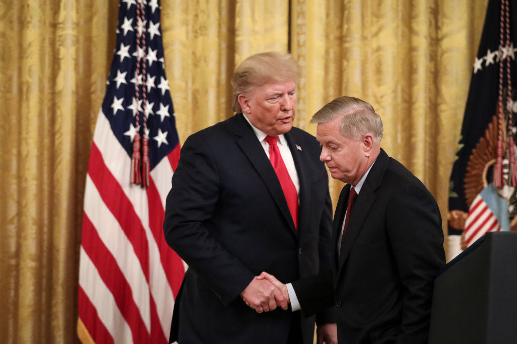 WASHINGTON, DC - NOVEMBER 6: (L-R) President Donald Trump shakes hands with Sen. Lindsey Graham (R-SC) during an event about judicial confirmations in the East Room of the White House on November 6, 2019 in Washington, DC. More than 150 of the president's federal judicial nominees have been confirmed by the Republican-controlled Senate. (Photo by Drew Angerer/Getty Images)