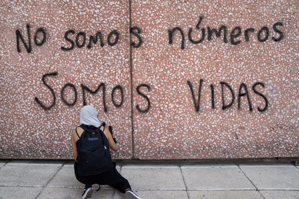 MEXICO CITY, MEXICO - MARCH 08: A demonstrator paints a graffiti that reads "we are not numbers, we are lives" during a rally on International Women's Day on March 8, 2020 in Mexico City, Mexico. (Photo by Toya Sarno Jordan/Getty Images)