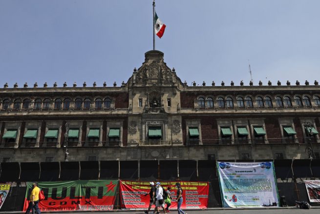 Banners with messages directed at Mexico's President Andres Manuel Lopez Obrador hang from a perimeter fence set up in front of the National Palace as preparation for the upcoming International Women's Day demonstration, in Mexico City, Friday, March 5, 2021. Marked on March 8th, the day has been sponsored by the United Nations since 1975, to celebrate women’s achievements and aims to further their rights. (AP Photo/Eduardo Verdugo)
