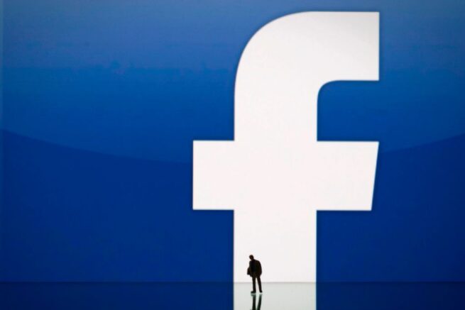 A picture taken on May 14, 2012 in Paris, shows an illustration made with a figurine set up in front of Facebook's homepage. Facebook, already assured of becoming one of the most valuable US firms when it goes public later this month, now must convince investors in the next two weeks that it is worth all the hype. Top executives at the world's leading social network have kicked off their all-important road show on Wall Street -- an intense marketing drive ahead of the company's expected trading launch on the tech-heavy Nasdaq on May 18. AFP PHOTO/JOEL SAGET (Photo by Joël SAGET / AFP) (Photo credit should read JOEL SAGET/AFP via Getty Images)