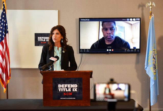 South Dakota Gov. Kristi Noem in Sioux Falls on Monday, March, 22, 2021, discusses an initiative for "protecting fairness in women's sports" by banning transgender women from participating in women's sports leagues. Herschel Walker, a retired professional football player, joined the news conference through a video call. (Argus Leader via AP)