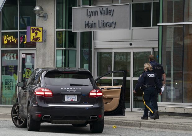 Members of the RCMP are seen outside of the Lynn Valley Library, in North Vancouver, British Columbia, Saturday, March 27, 2021. Police say multiple victims were stabbed inside and outside the library today. (Jonathan Hayward/The Canadian Press via AP)