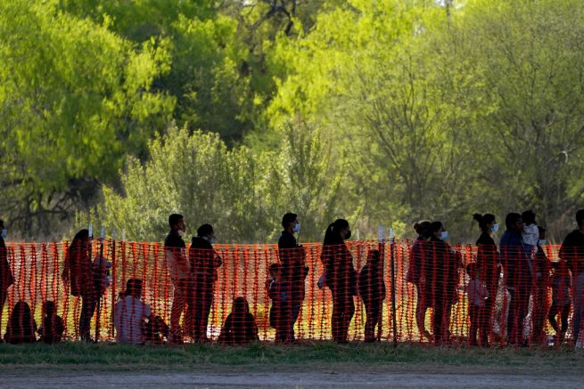 FILE - In this Friday, March 19, 2021, photo migrants are seen in custody at a U.S. Customs and Border Protection processing area under the Anzalduas International Bridge in Mission, Texas. The Biden administration is facing growing questions about why it wasn't more prepared for an influx of migrants at the southern border. The administration is scrambling to build up capacity to care for 14,000 young undocumented migrants now in federal custody — and more likely on the way. (AP Photo/Julio Cortez, File)