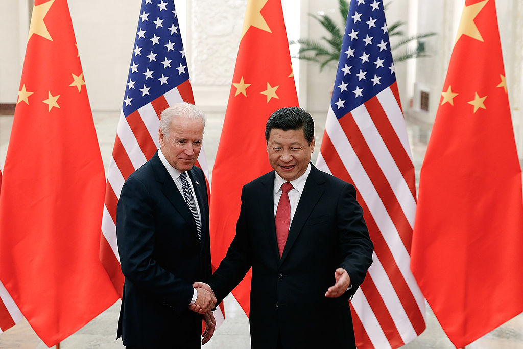 Chinese President Xi Jinping (R) shakes hands with US Vice President Joe Biden (L) inside the Great Hall of the People in Beijing on December 4, 2013. Biden arrived in Beijing to raise concerns over a Chinese air zone ramping up regional tensions, looking to bolster ties while also underscoring alliances with Tokyo and Seoul. His trip follows weeks of furore after Beijing declared an "air defence identification zone" (ADIZ) covering East China Sea islands disputed with Japan. AFP PHOTO / POOL (Photo credit should read LINTAO ZHANG/AFP via Getty Images)