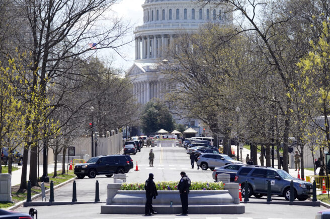 U.S. Capitol Police and National Guard soliders patrol near the U.S. Capitol after a car crashed into a barrier on Capitol Hill near the Senate side of the U.S. Capitol in Washington, Friday, April 2, 2021. (AP Photo/Alex Brandon)