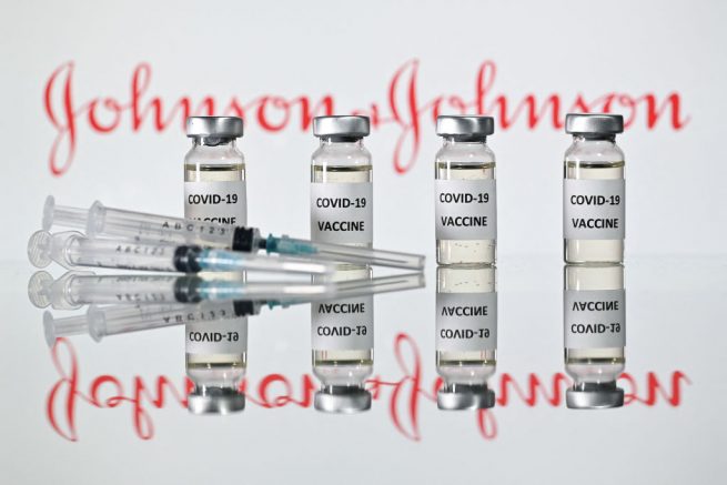 An illustration picture shows vials with Covid-19 Vaccine stickers attached and syringes with the logo of US pharmaceutical company Johnson &amp; Johnson on November 17, 2020. (Photo by JUSTIN TALLIS / AFP) (Photo by JUSTIN TALLIS/AFP via Getty Images)