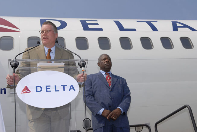 ATLANTA - JUNE 18: Delta Air Lines CFO Ed Bastian (L) speaks as Hank Aaron looks on before Aaron's photo was unveiled on a Boeing 757 June 18, 2007 in Atlanta, Georgia. Aaron hit 755 home runs during his career. (Photo by Barry Williams/Getty Images)