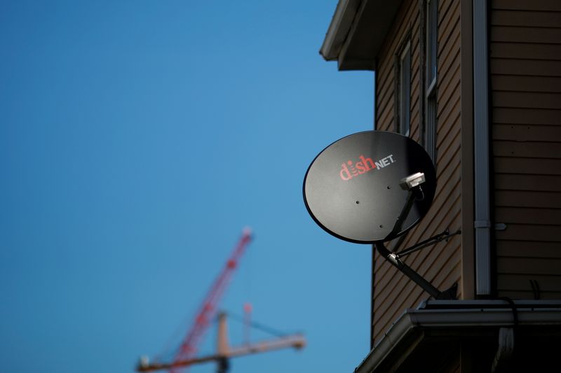 FILE PHOTO: A Dish Network receiver hangs on a house in Somerville