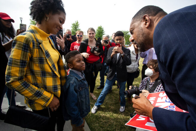 Vernon Jones autographs a sign for a young boy after declaring his intention to run for governor of Georgia as a Republican in Atlanta, on Friday, April 16, 2021. Jones, a former Democrat, is looking to ride a wave of Trump supporters' discontent with Gov. Brian Kemp to the Republican nomination. (AP Photo/Ron Harris)
