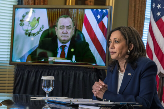 Vice President Kamala Harris meets virtually with Guatemala's President Alejandro Giammattei, seen on screen at left, Monday, April 26, 2021, from her ceremonial office at the Eisenhower Executive Office Building on the White House complex in Washington. (AP Photo/Jacquelyn Martin)