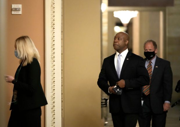  WASHINGTON, DC - APRIL 28: Sen. Tim Scott (R-SC) walks through the U.S. Capitol before he delivers the republican response to President Biden's address to congress April 28, 2021 in Washington, DC. On the eve of his 100th day in office, Biden spoke about his plan to revive America’s economy and health as it continues to recover from a devastating pandemic. He delivered his speech before 200 invited lawmakers and other government officials instead of the normal 1600 guests because of the ongoing COVID-19 pandemic. (Photo by Drew Angerer/Getty Images)