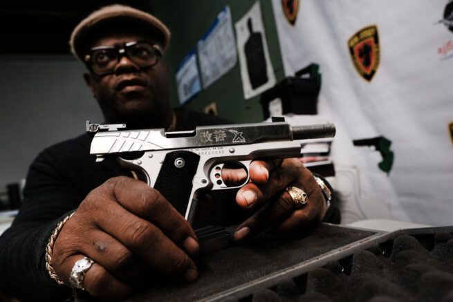 JERSEY CITY - MARCH 25: Lateif Dickerson displays one of his prized pistols at his gun instruction headquarters on March 25, 2021 in Jersey City, New Jersey. Dickerson, a weapons specialist who teaches marksmanship and gun handling, is a firm believer in the Second Amendment and the right to own firearms. In the wake of recent mass shootings, the Biden administration is pushing for the Senate to pass gun legislation already passed by the House. Area gun businesses have seen a rise in sales recently that has even led to a shortage of bullets. (Photo by Spencer Platt/Getty Images)